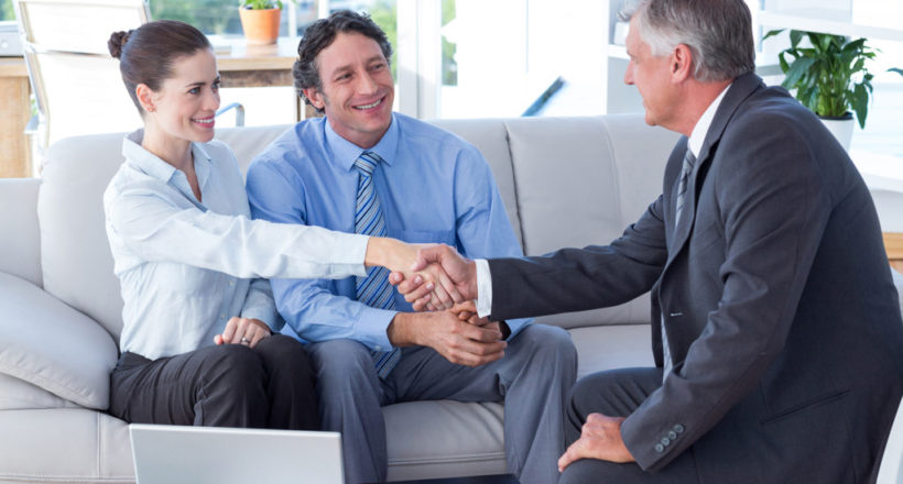 couple in meeting with a financial adviser in living room