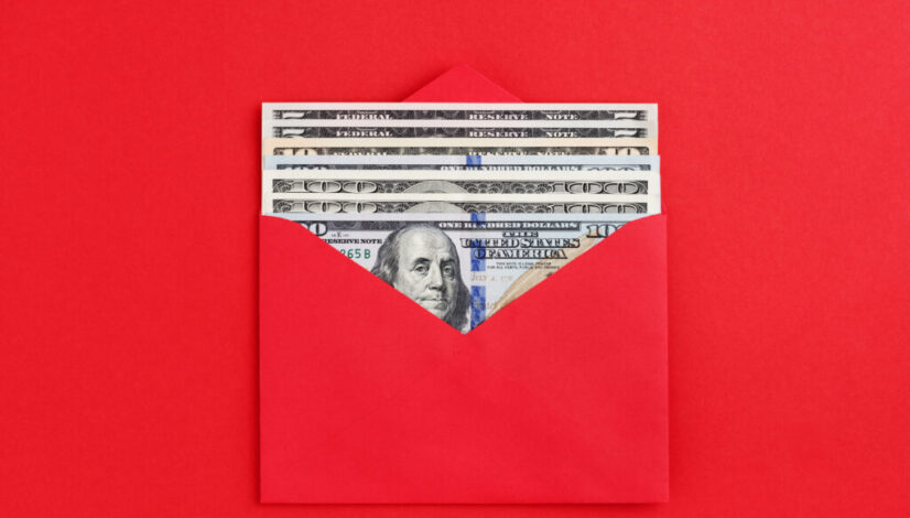 US dollars in cash in red envelope