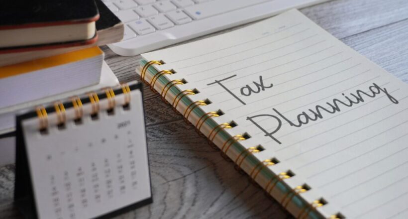 closeup-image-of-notebook-with-text-tax-planning-a-2023-11-27-05-13-13-utc