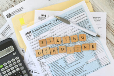 irs-tax-forms-1040-words-filing-deadline-in-wooden-2023-11-27-05-23-30-utc