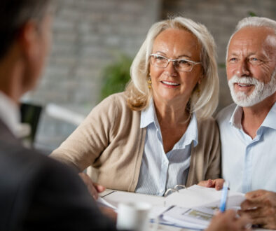 Happy senior couple having a meeting with real estate agent.